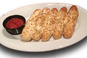 Cheesy bread sticks and marinara sauce on a plate